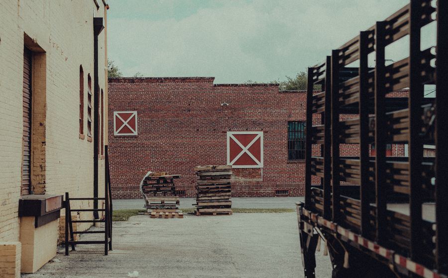 Truck staged at a warehouse dock with pallets ready for dispatch