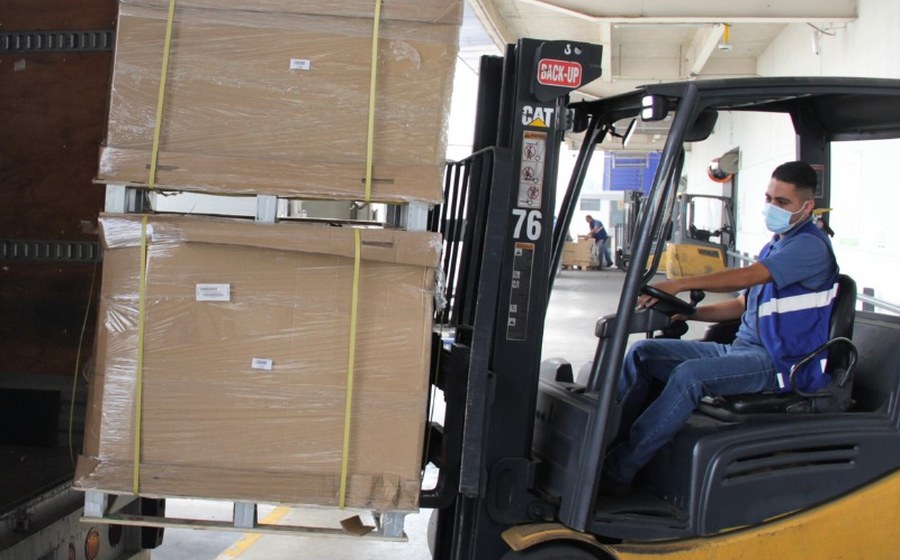 Forklift loading material onto a delivery truck